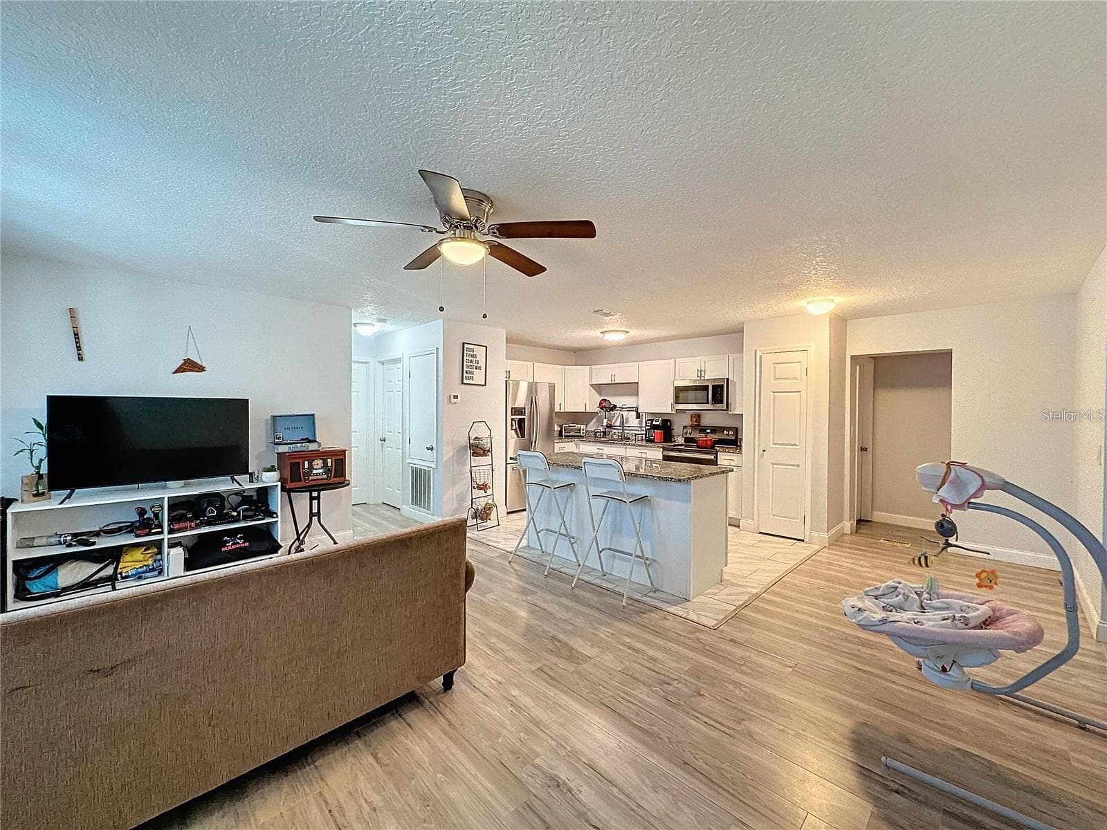 FRONT SIDE ANGLE LIVING ROOM KITCHEN - 7211 PINION DR, ORLANDO