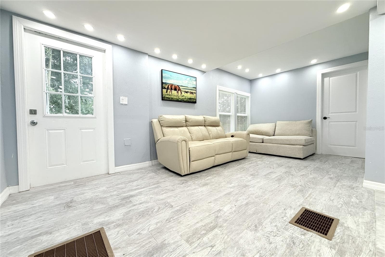 LIVING ROOM EXIT  TO DECK AND BACK YARD - 6934 AZLEE AVE, NEW PORT RICHEY