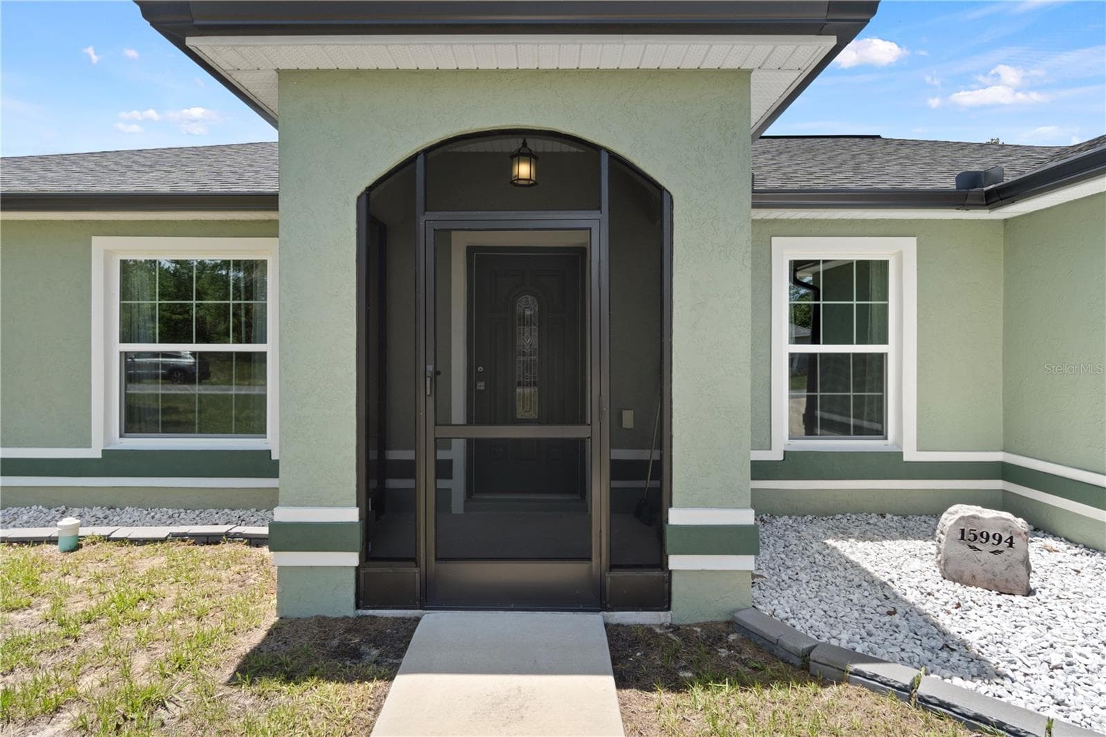 A welcoming screened front porch sets the tone before you even step inside. - 15994 SW 55TH AVENUE RD, OCALA