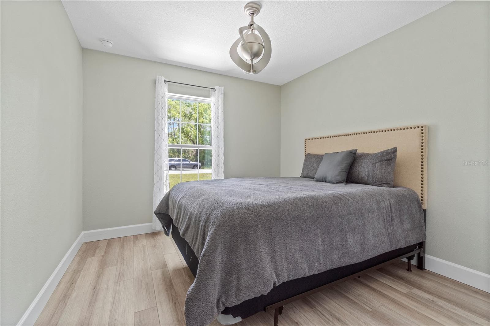 Spacious secondary bedroom with ample closet space, split from the owner's suite for privacy. - 15994 SW 55TH AVENUE RD, OCALA