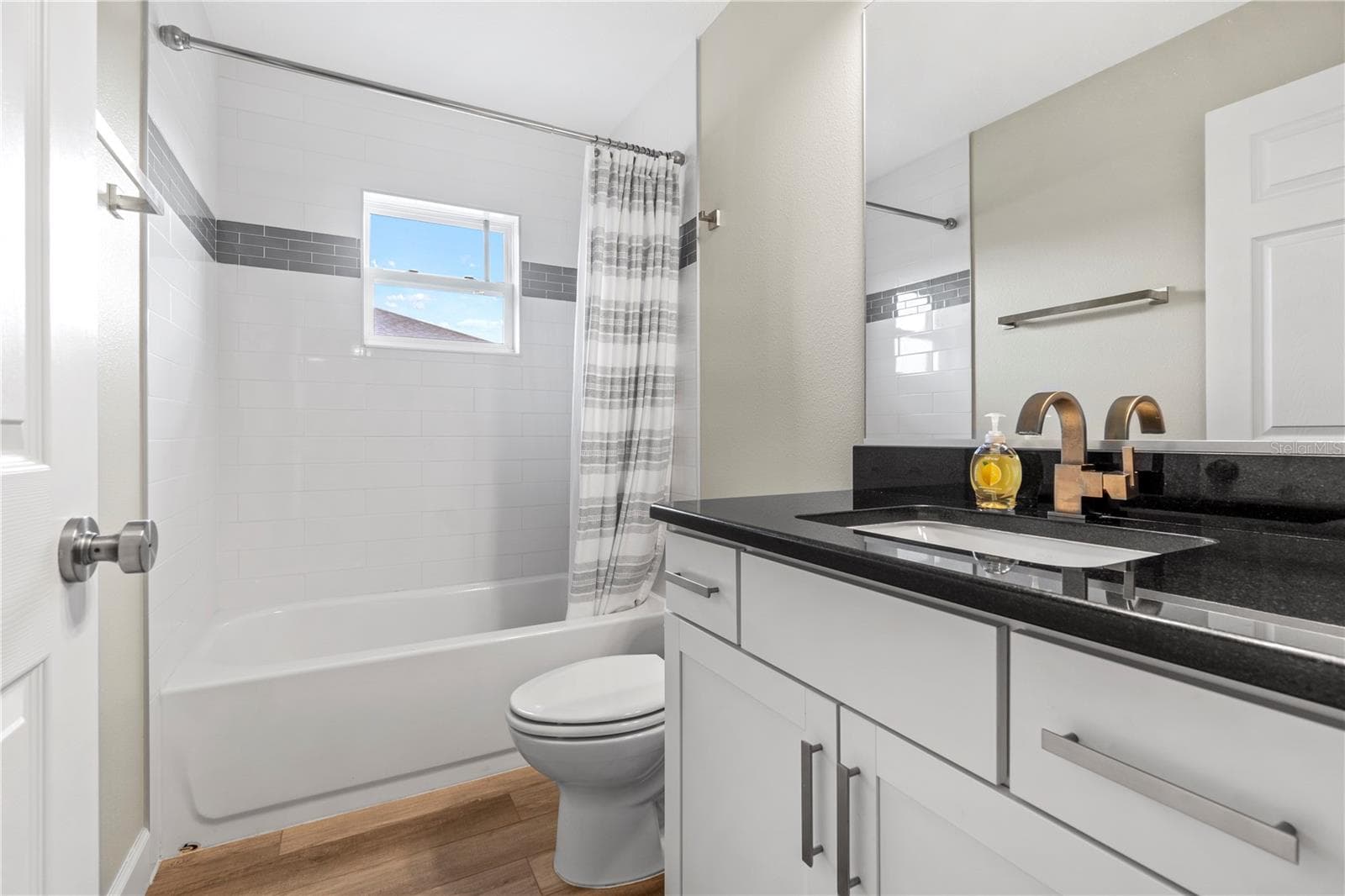 Stylish second full bath serves the secondary bedrooms. - 15994 SW 55TH AVENUE RD, OCALA