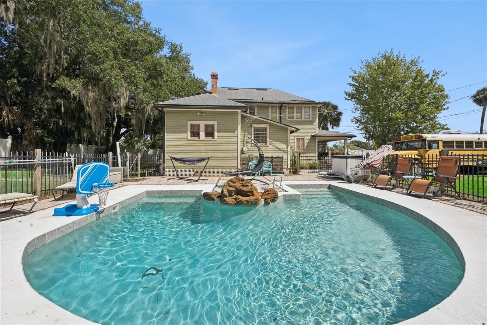 A private saltwater pool brings Florida living home, surrounded by outdoor entertaining space and the property's expansive grounds. - 2201 CELERY AVE, SANFORD