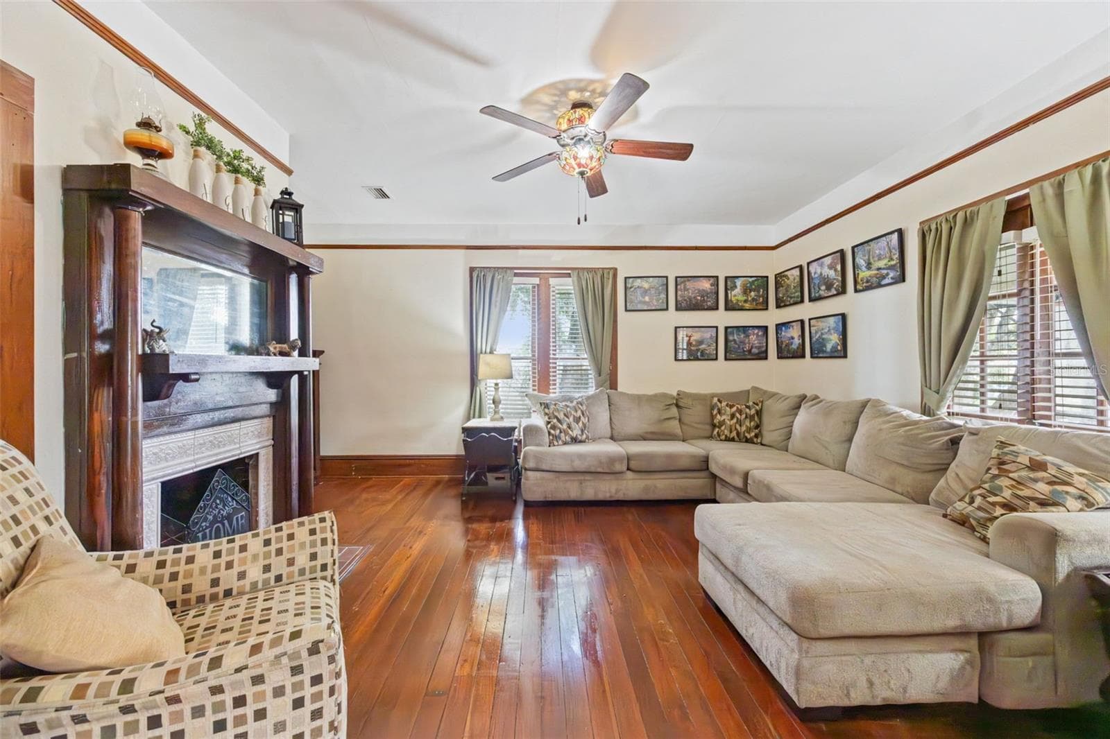 The spacious living room opens through original French doors to the central hall, preserving the home's classic floor plan and architectural detail. - 2201 CELERY AVE, SANFORD