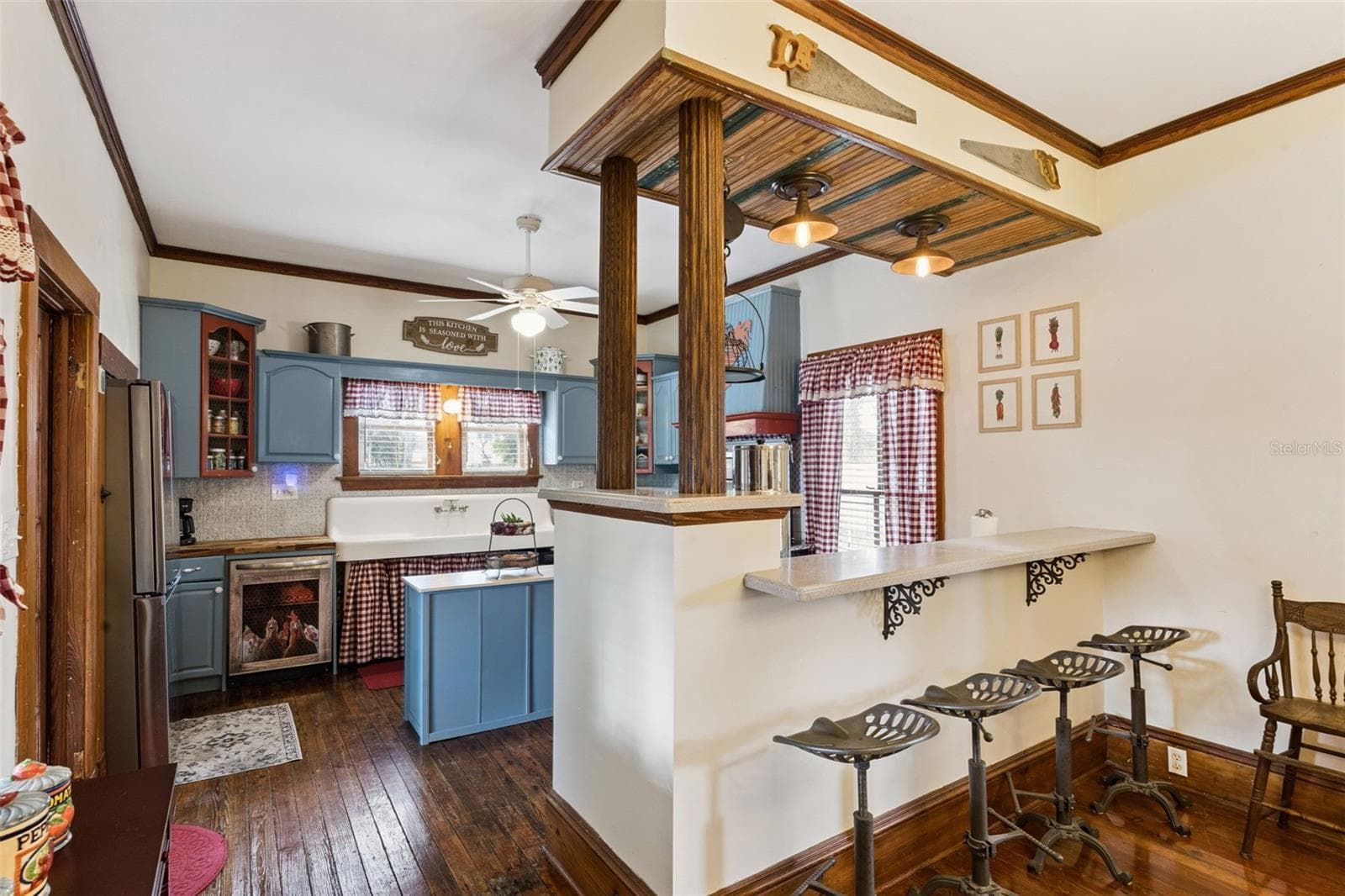 An open pass-through and breakfast bar connect the dining room and kitchen while preserving the character of each space. - 2201 CELERY AVE, SANFORD