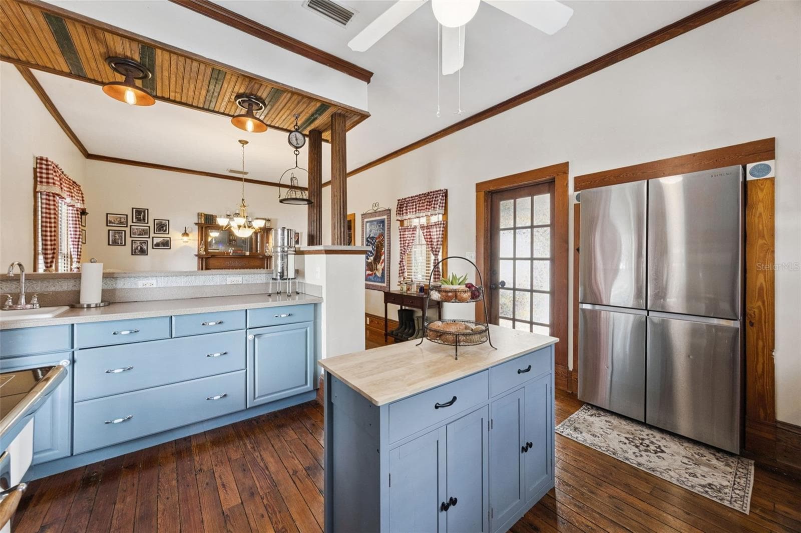 The kitchen offers a center island, abundant cabinetry and a natural connection to the adjoining dining space. - 2201 CELERY AVE, SANFORD
