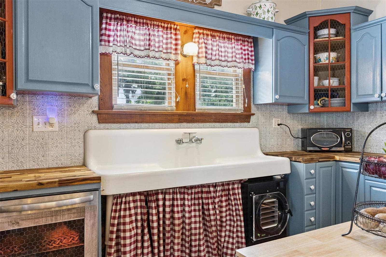 A reverse view highlights additional workspace, storage, stainless-steel refrigeration and the kitchen's functional layout. - 2201 CELERY AVE, SANFORD