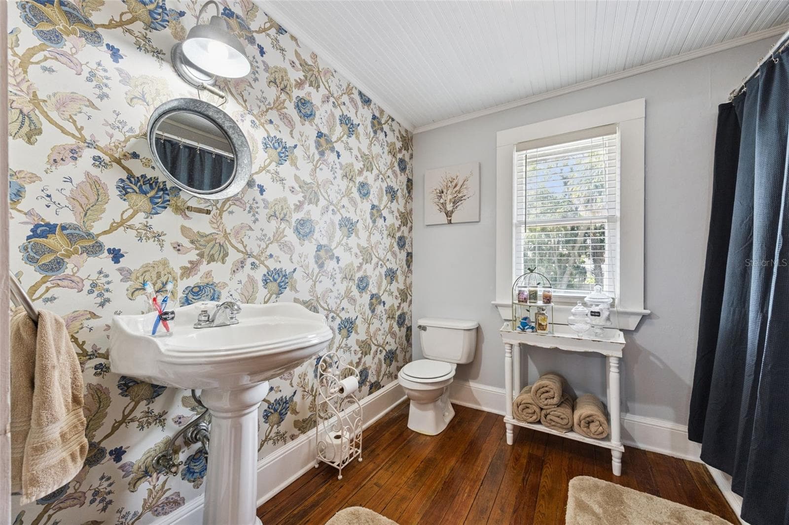 A second beautifully styled bath pairs a clawfoot tub and pedestal sink with classic black-and-white tilework. - 2201 CELERY AVE, SANFORD