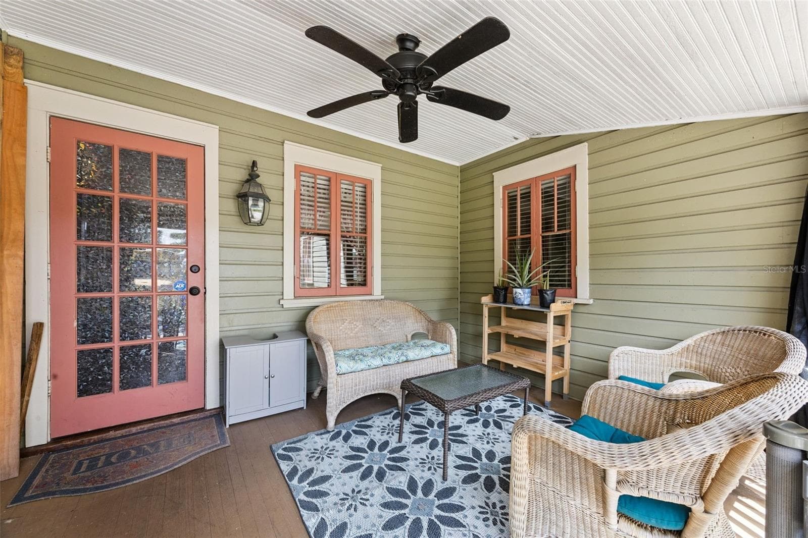 Another inviting corner of the covered porch creates a comfortable outdoor sitting room. - 2201 CELERY AVE, SANFORD