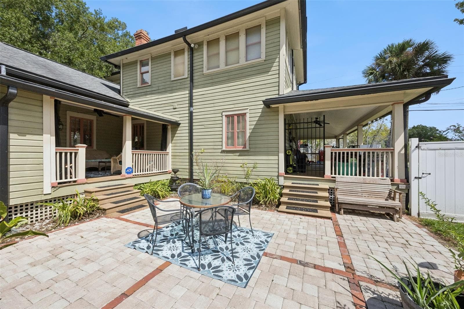 An expansive paver courtyard creates a substantial outdoor entertaining area between the home, porch and pool. - 2201 CELERY AVE, SANFORD
