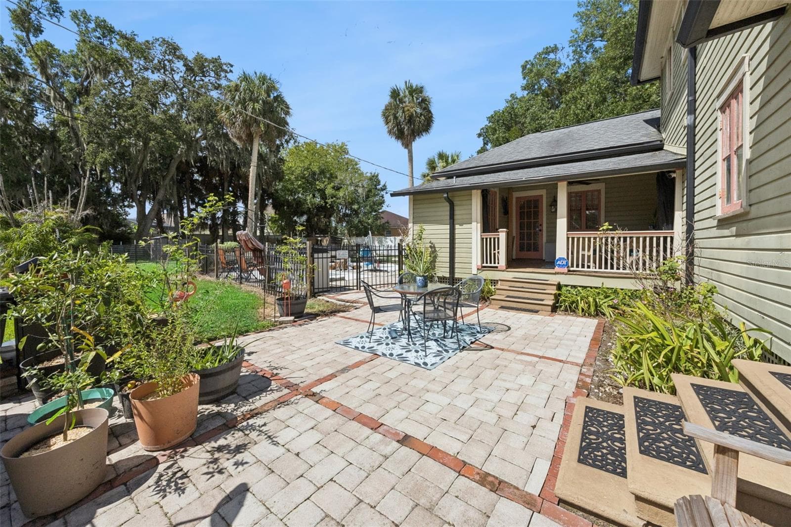 The courtyard connects the home's outdoor living areas while providing plenty of room for dining, gardening and entertaining. - 2201 CELERY AVE, SANFORD