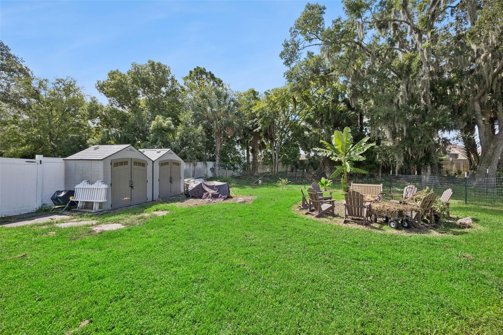 A large backyard with mature shade trees, firepit area and outbuildings creates a setting rarely found this close to Sanford. - 2201 CELERY AVE, SANFORD