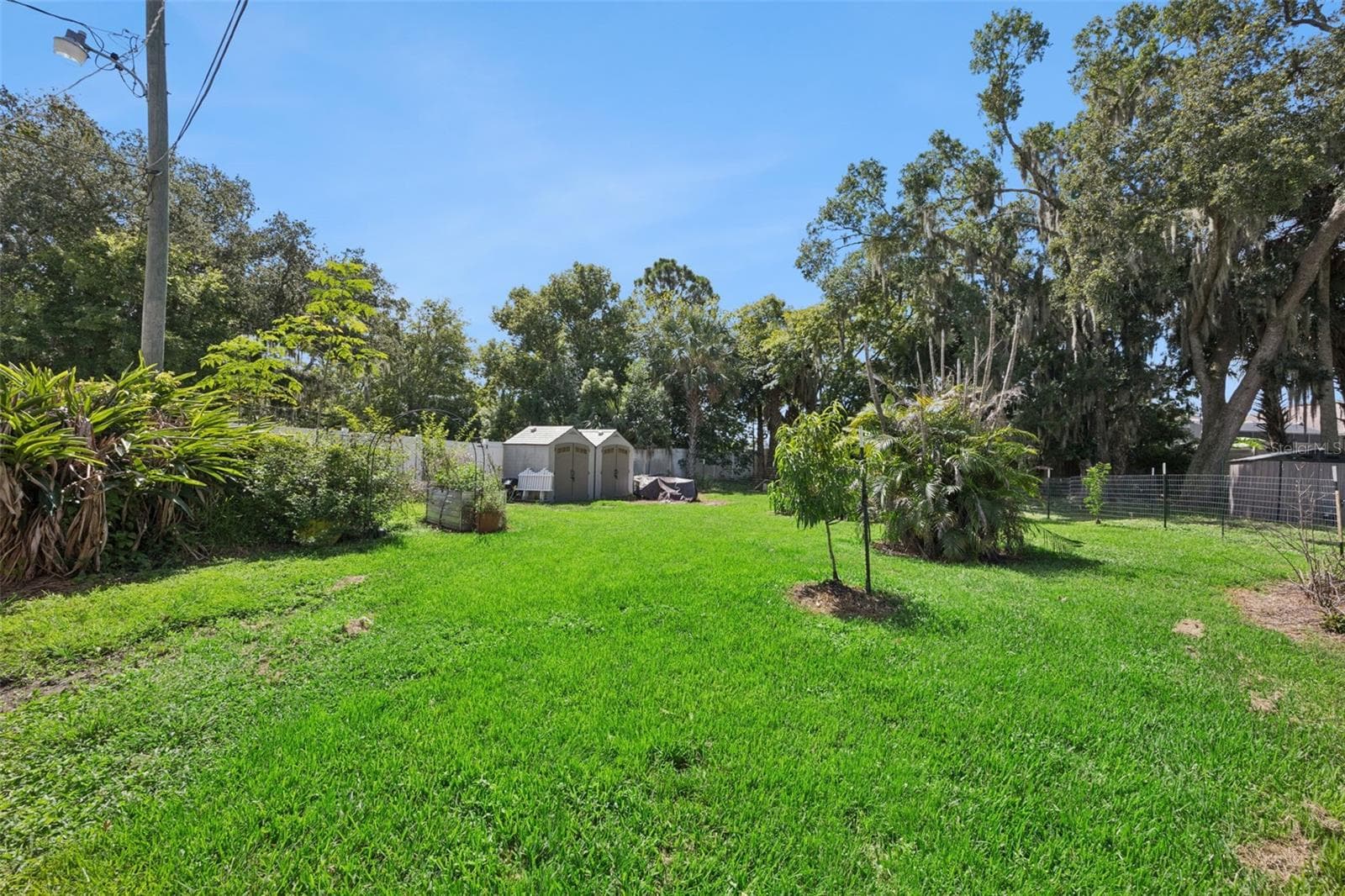 Expansive green space, established garden areas and outbuildings add to the property's flexibility and homestead appeal. - 2201 CELERY AVE, SANFORD