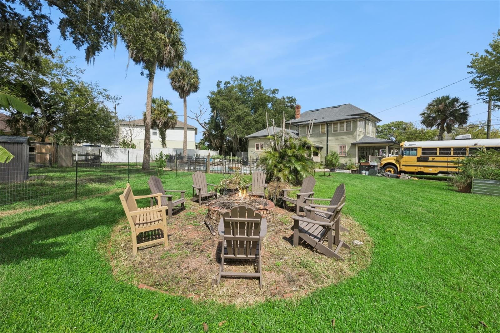 Gather around the backyard firepit beneath mature palms and shade trees — another outdoor space designed to be enjoyed. - 2201 CELERY AVE, SANFORD