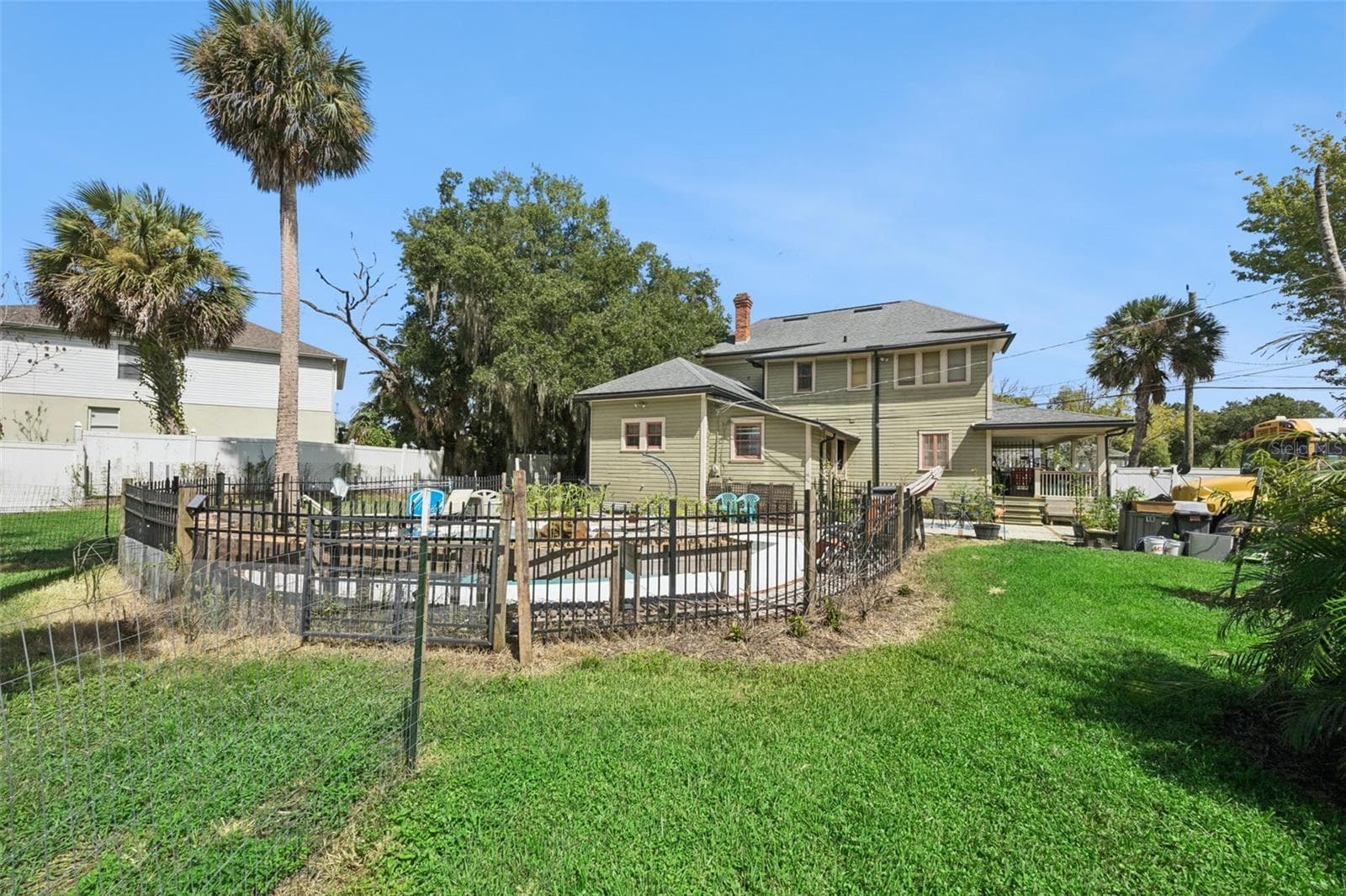 Gather around the backyard firepit beneath mature palms and shade trees — another outdoor space designed to be enjoyed. - 2201 CELERY AVE, SANFORD