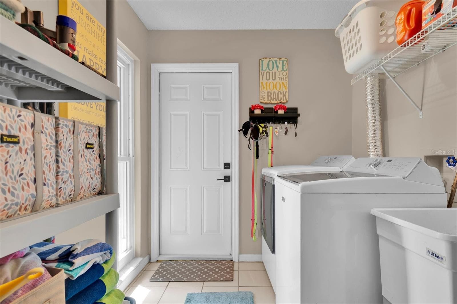 LAUNDRY ROOM TO GARAGE - 207 AMESBURY CIR, SUN CITY CENTER