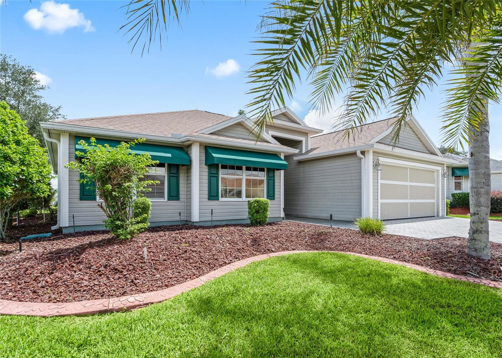 The spacious CORNER LOT showcases the home’s attractive landscaping, architectural details and welcoming curb appeal. - 17601 SE 81ST TIMBERWOOD TER, THE VILLAGES