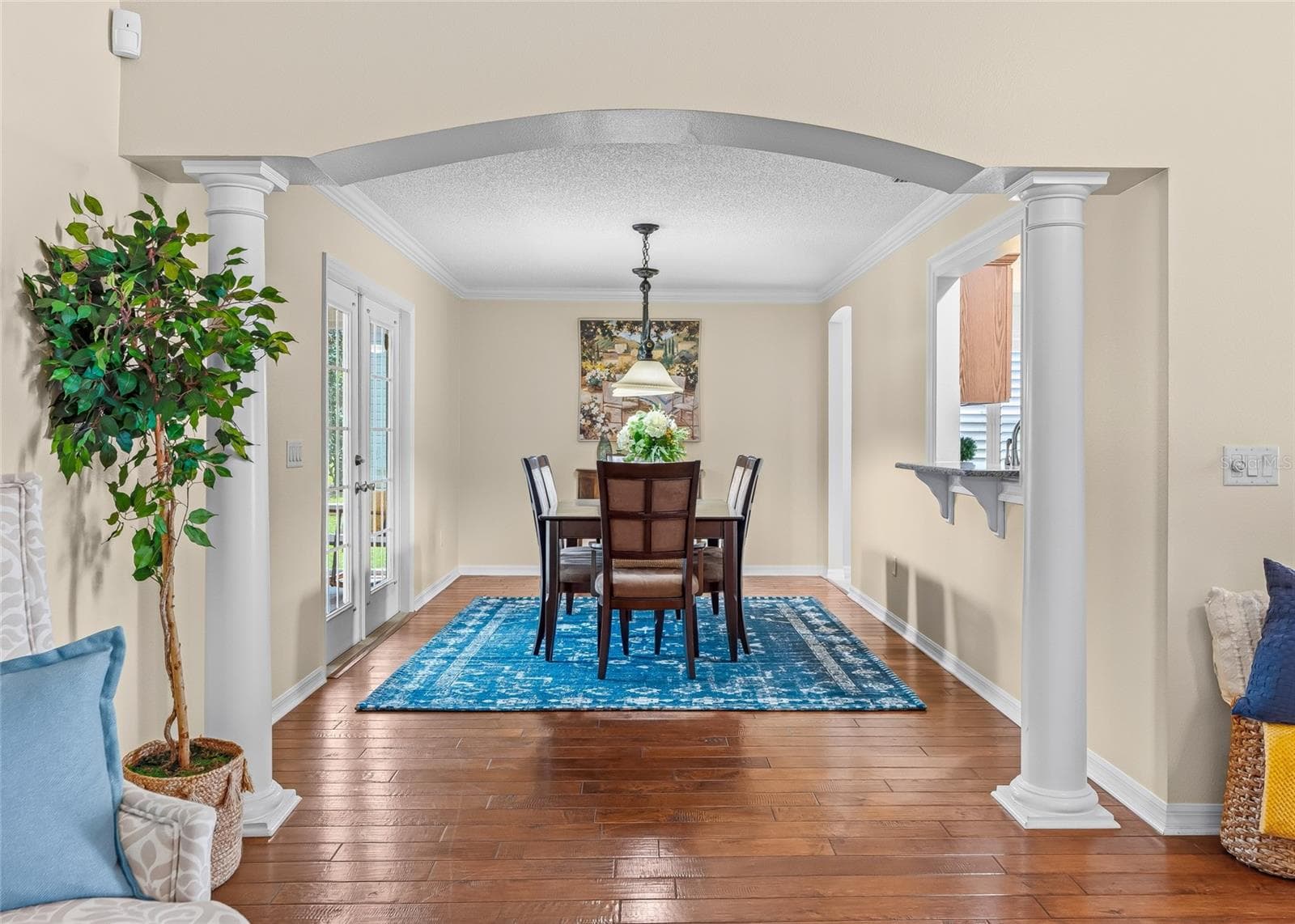 Spacious Formal Dining Room is beautifully defined by an arched opening and decorative columns, while remaining open to the main living area—perfect for entertaining family and friends. - 17601 SE 81ST TIMBERWOOD TER, THE VILLAGES