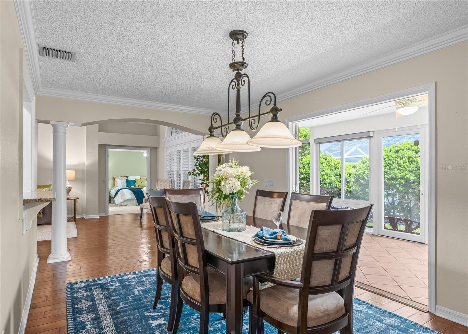 Another view of the Dining Room highlights the easy flow into the enclosed Florida Room, adding even more usable living and entertaining space. - 17601 SE 81ST TIMBERWOOD TER, THE VILLAGES