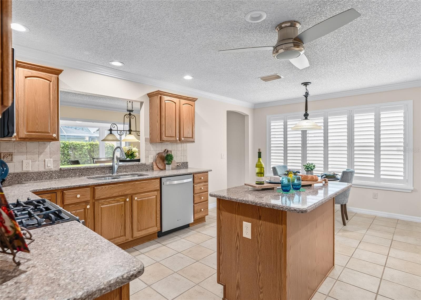 Bright breakfast area is surrounded by PLANTATION SHUTTERS and opens directly to the kitchen, creating a comfortable spot for everyday meals and morning coffee. - 17601 SE 81ST TIMBERWOOD TER, THE VILLAGES