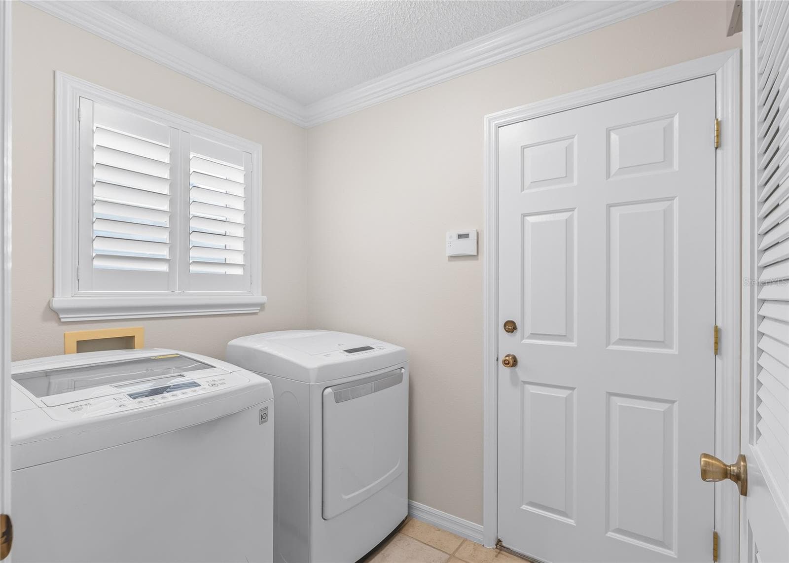 Convenient INSIDE LAUNDRY ROOM with washer and dryer, plantation shutters and direct access to the garage. - 17601 SE 81ST TIMBERWOOD TER, THE VILLAGES