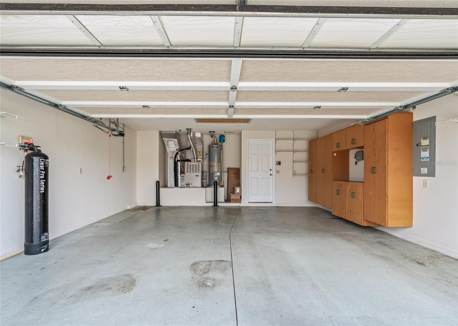 Spacious TWO-CAR GARAGE offers excellent storage with built-in cabinetry, utility shelving and plenty of room for vehicles and everyday necessities. - 17601 SE 81ST TIMBERWOOD TER, THE VILLAGES