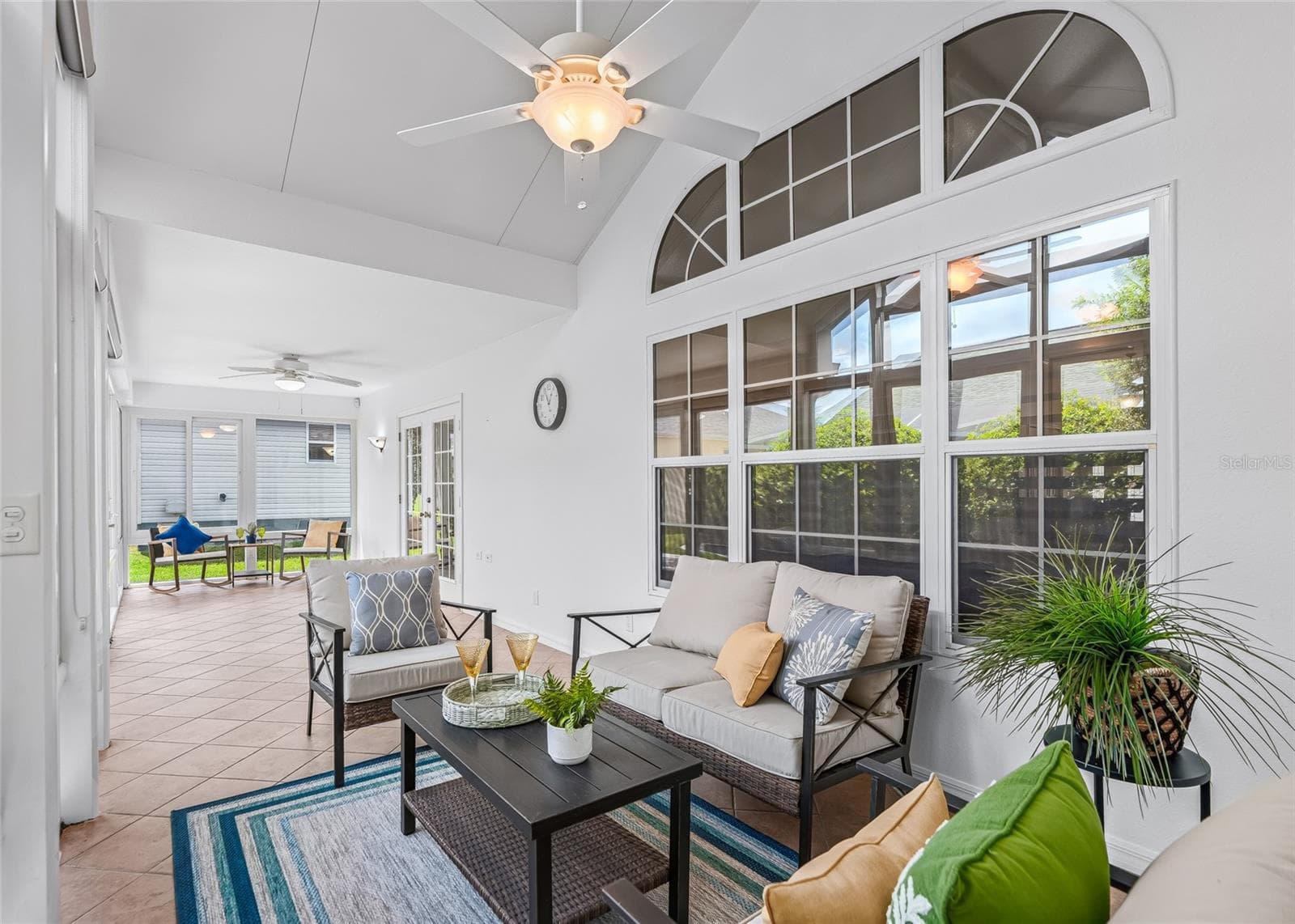 The impressive Florida Room features a soaring vaulted ceiling, tiled flooring, ceiling fans and walls of windows—perfect for relaxing, entertaining or creating multiple conversation areas. - 17601 SE 81ST TIMBERWOOD TER, THE VILLAGES