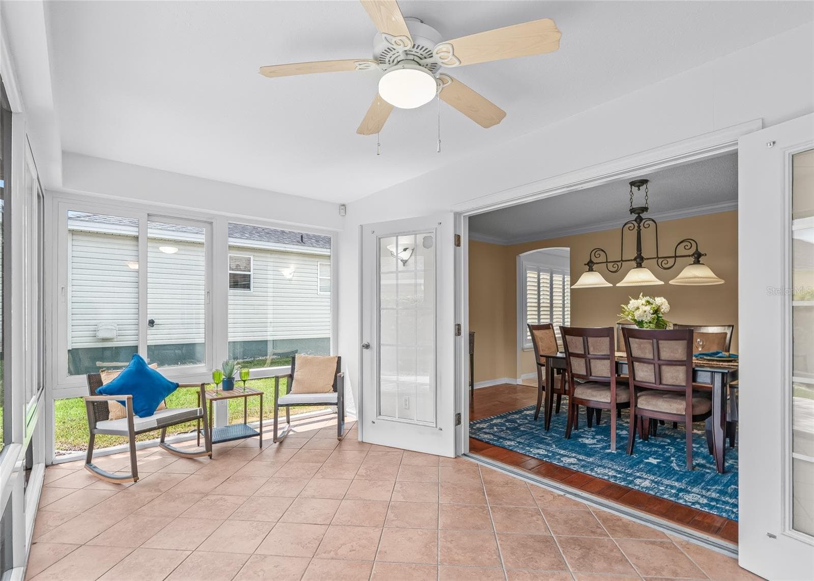 The enclosed Florida Room connects beautifully to the Formal Dining Room through wide French doors, creating an easy flow for entertaining and everyday living. - 17601 SE 81ST TIMBERWOOD TER, THE VILLAGES