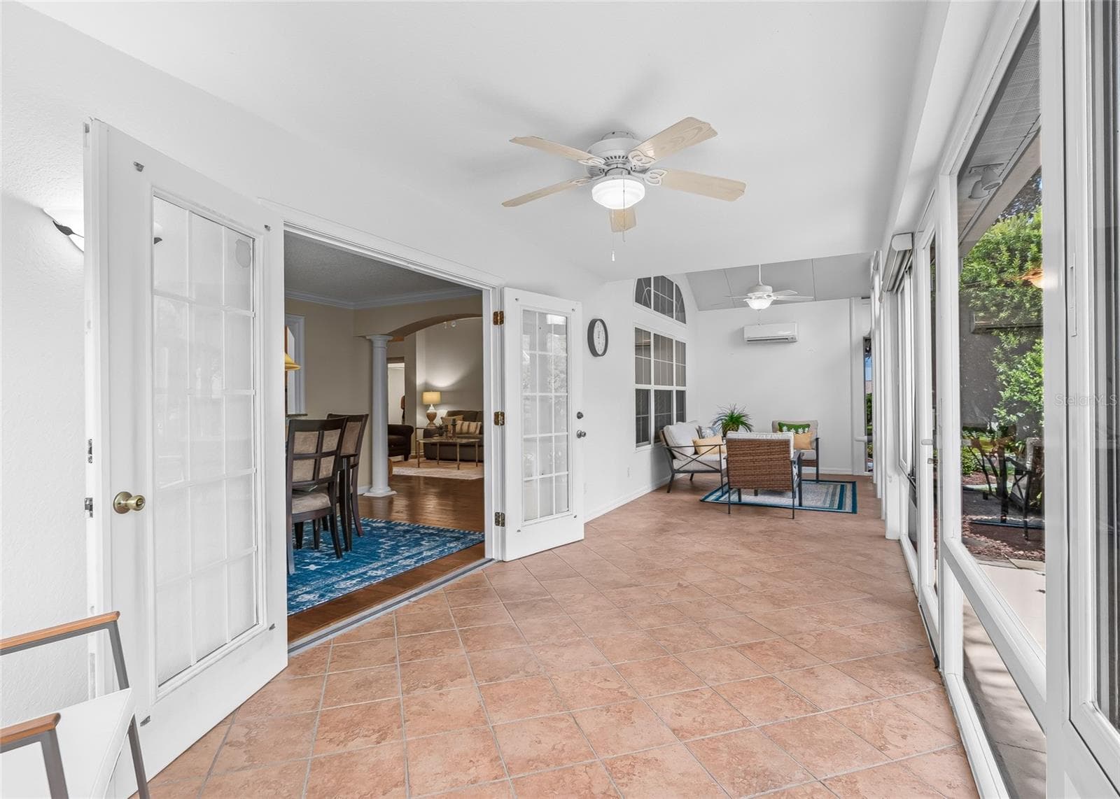 Another expansive view of the Florida Room highlights its generous length, tiled flooring, ceiling fans, vaulted ceiling and dedicated AC for year-round comfort. - 17601 SE 81ST TIMBERWOOD TER, THE VILLAGES