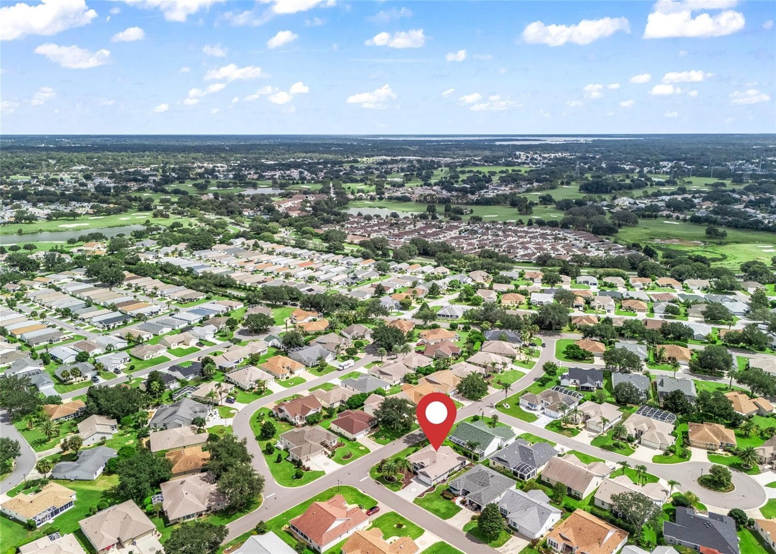 Aerial view with location marker highlights the home’s convenient position within the Village of Piedmont and its setting among attractive, well-kept neighboring homes. - 17601 SE 81ST TIMBERWOOD TER, THE VILLAGES
