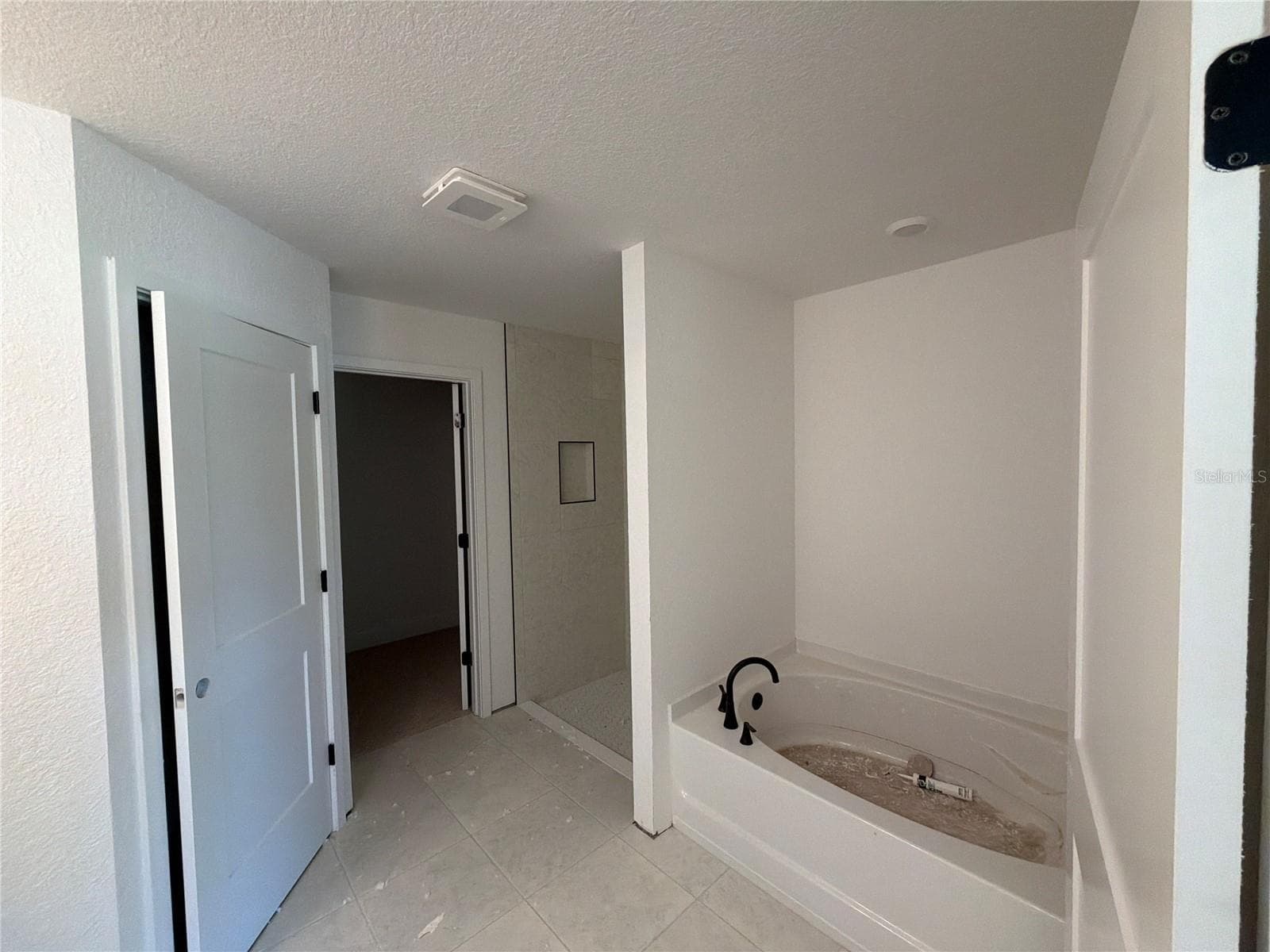 Under construction. Current state of build as of 9-5-26. Master Bath. - 7 BAHIA PASS LN, OCALA