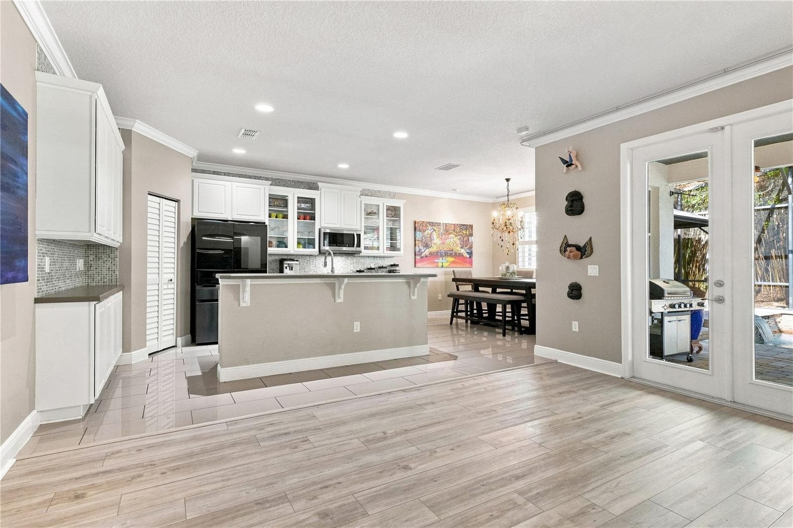 Kitchen, Dining Room, & French Patio Door view from Family Room - 13547 PITANGA ST, CLERMONT
