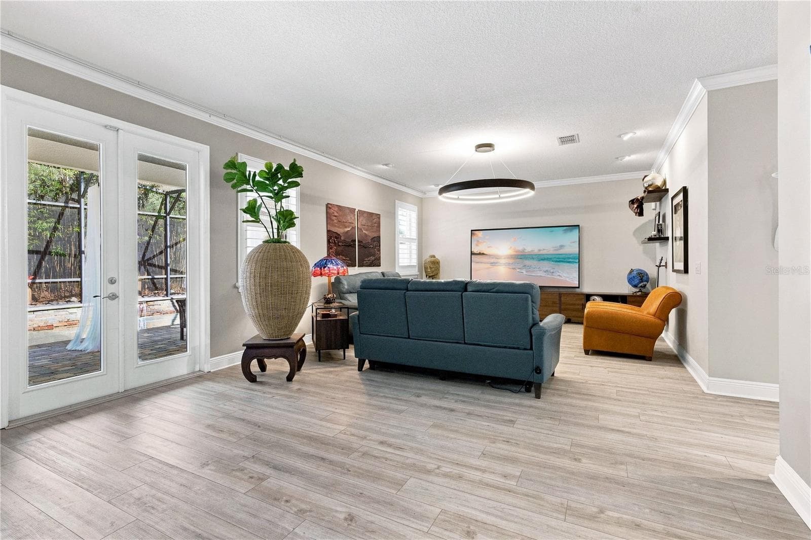 Family room with french doors to the outdoor retreat. - 13547 PITANGA ST, CLERMONT