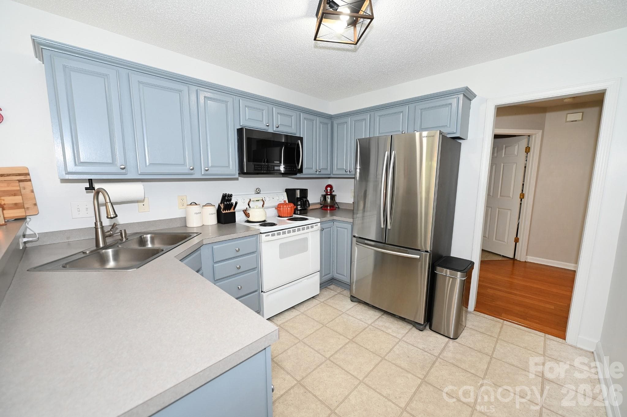 Kitchen with doorway to the half bath and laundry room - 236 17th Avenue SE, Hickory