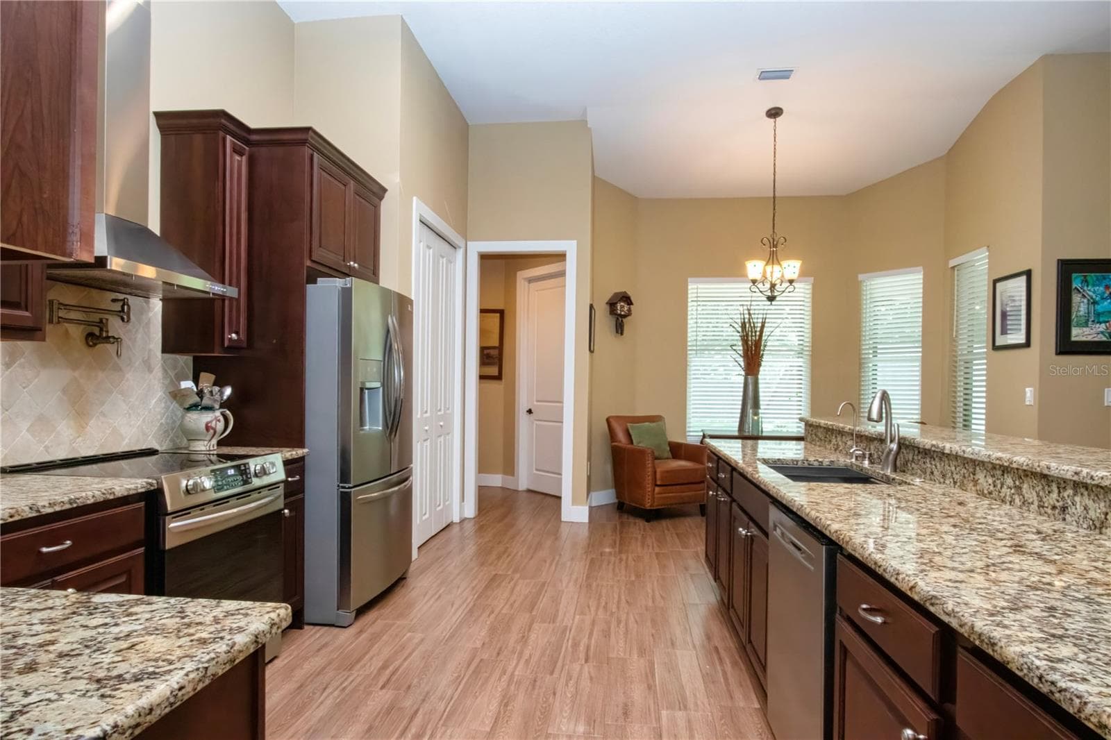 chefs kitchen exppansive breakfast bar and countertops with tons of storage and prep space - 1605 BUTCH CASSIDY TRL, WIMAUMA