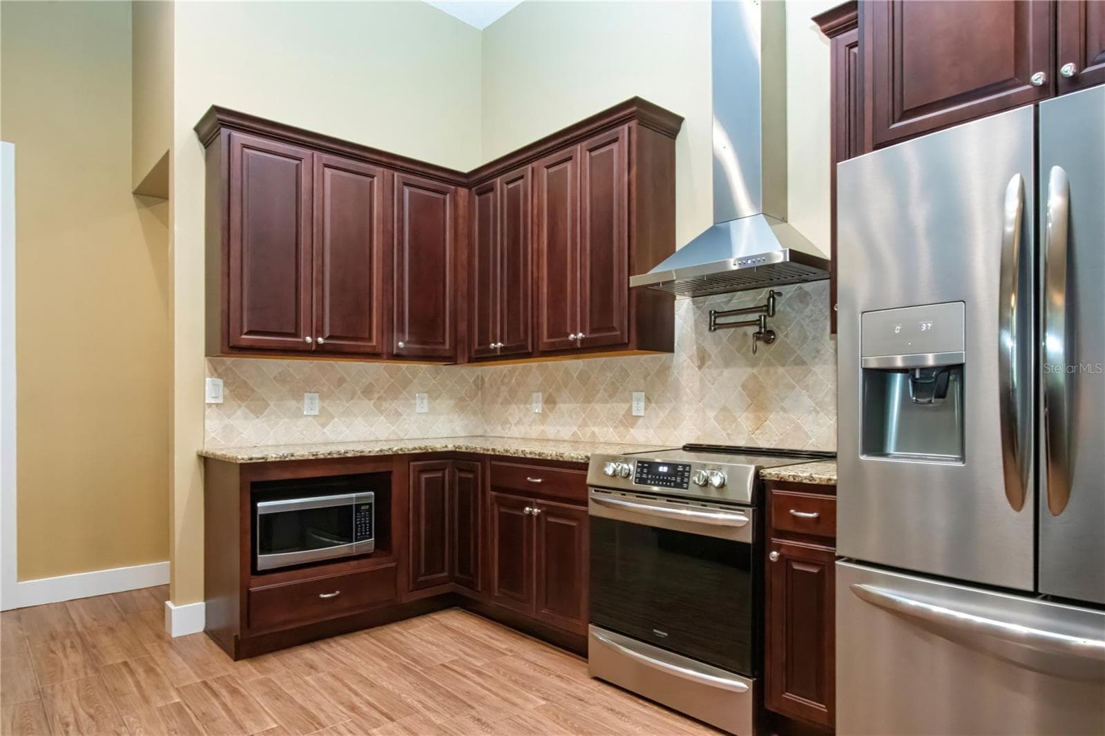 other side with stainless convection oven and regrigerator - 1605 BUTCH CASSIDY TRL, WIMAUMA
