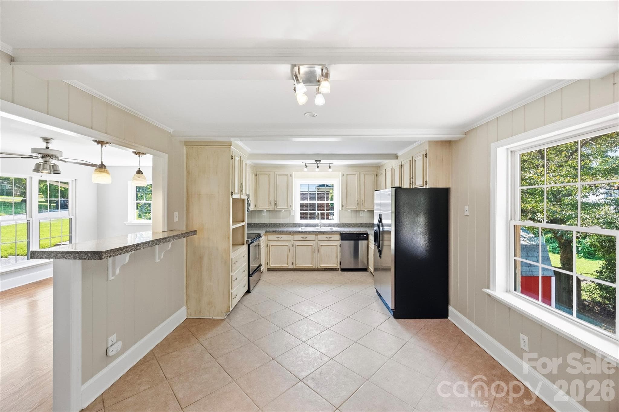 True to the homes mid-century modern roots, the kitchen unfolds in a long, linear layout framed by 2 windows that bring in the light. A thoughtfully designed wrap around cabinet system provides generous storage and impressive countertop space. - 6506 Candlewood Drive, Charlotte