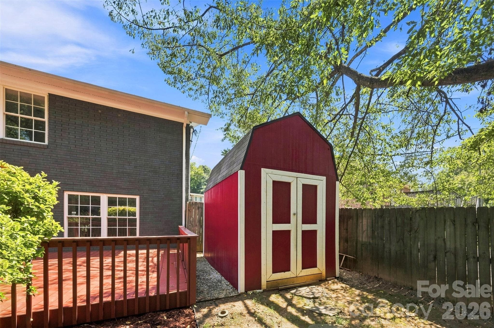 This is a good look at the Freshly painted deck and charming red barn-style outbuilding. - 6506 Candlewood Drive, Charlotte
