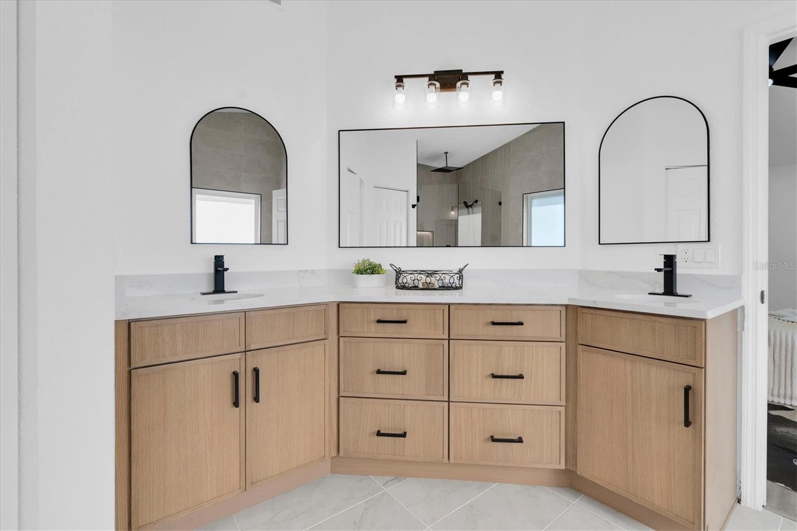 Dual vanities, private water closet and generous storage complete the redesigned primary bath. - 630 PINTA DR, TIERRA VERDE