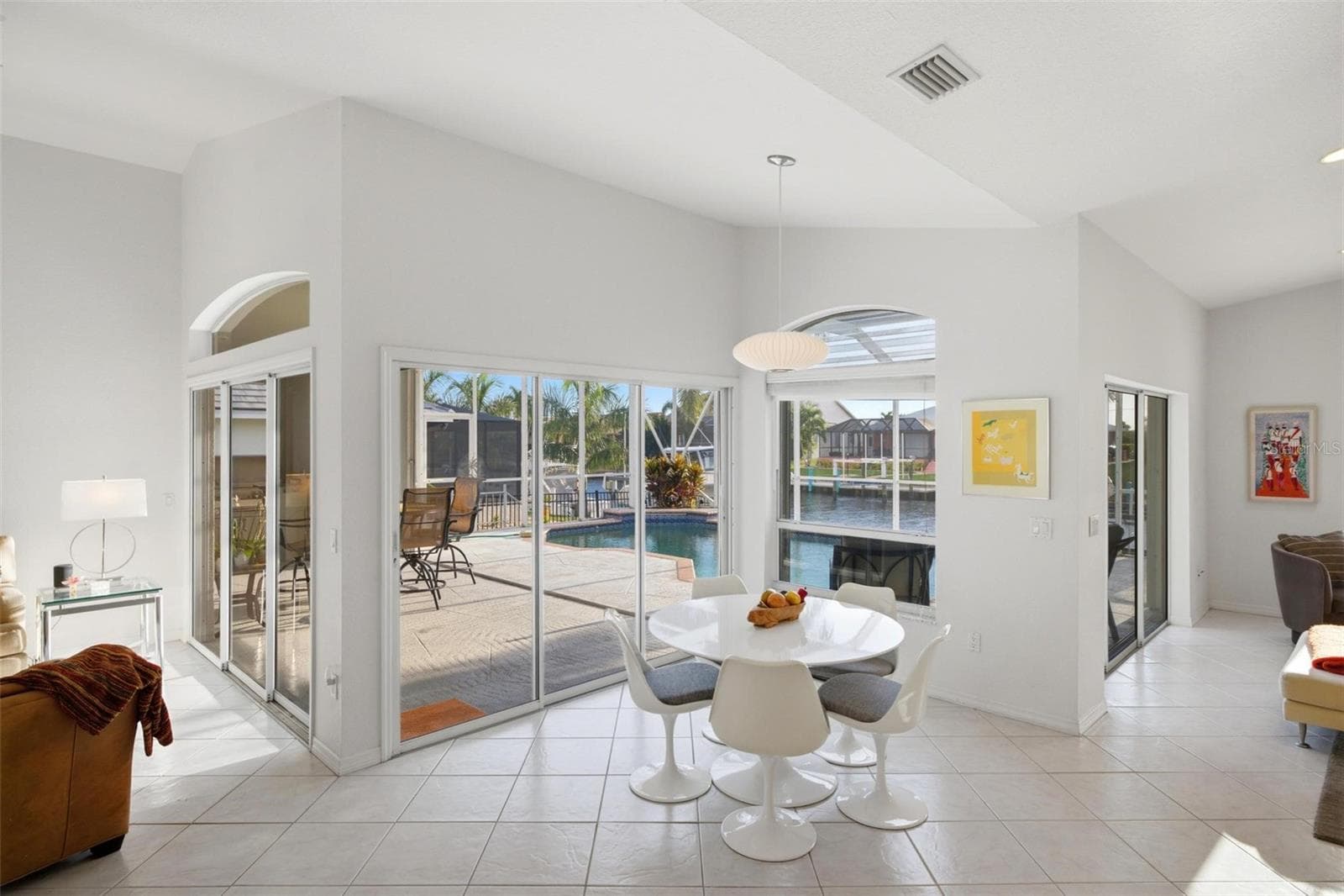 kitchen nook has a slider and large windows surrounding it. - 209 DIVINCI DR, PUNTA GORDA