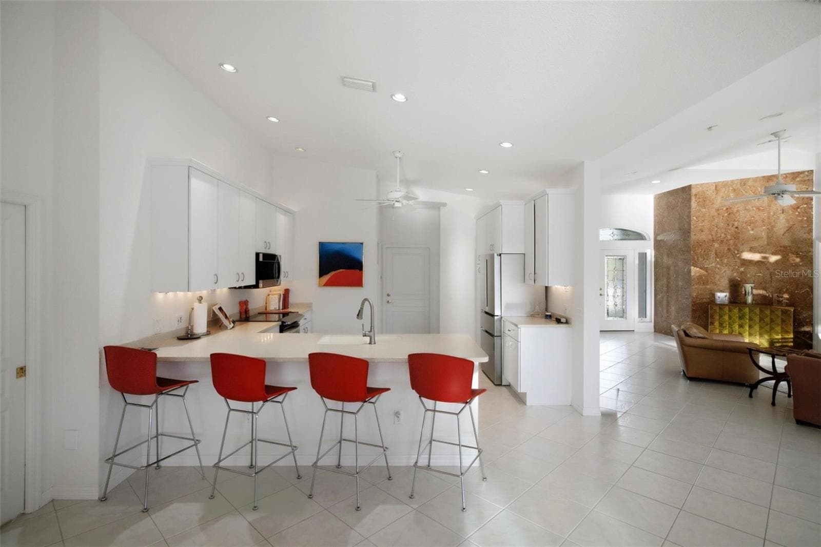 breakfast bar comfortably seats 4 and is open to the nook, kitchen and family room - 209 DIVINCI DR, PUNTA GORDA