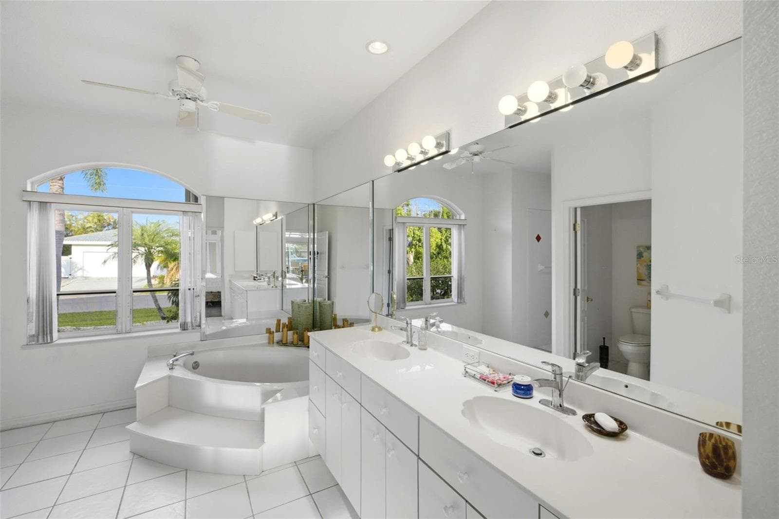 Primary en suite bathroom has a double sink, garden tub, private lavatory, walk in shower and a linen closet. - 209 DIVINCI DR, PUNTA GORDA