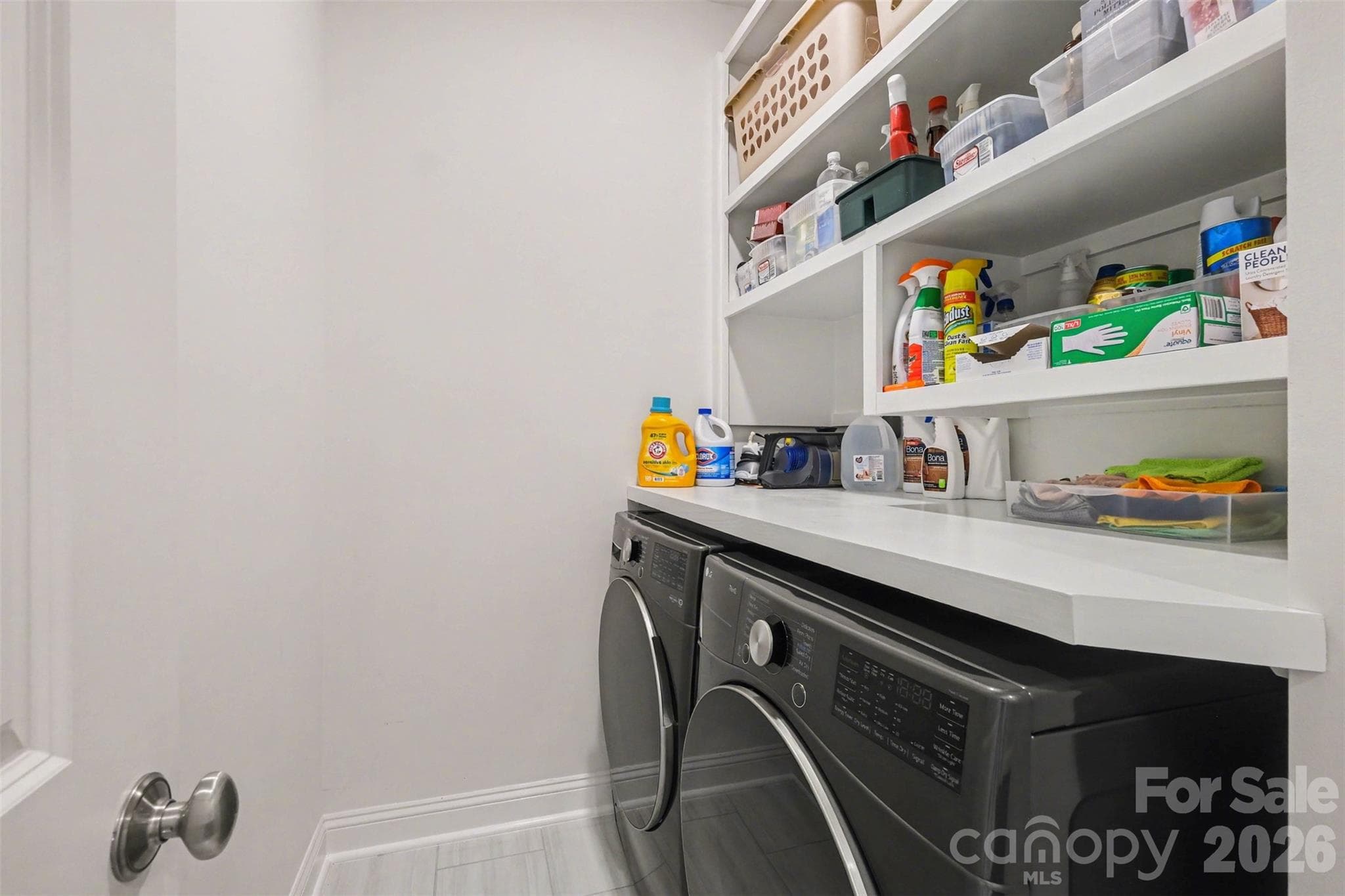 The laundry room - on the same level as bedrooms - includes a folding counter and shelves for extra organization! - 3743 Keyworth Way, Indian Land