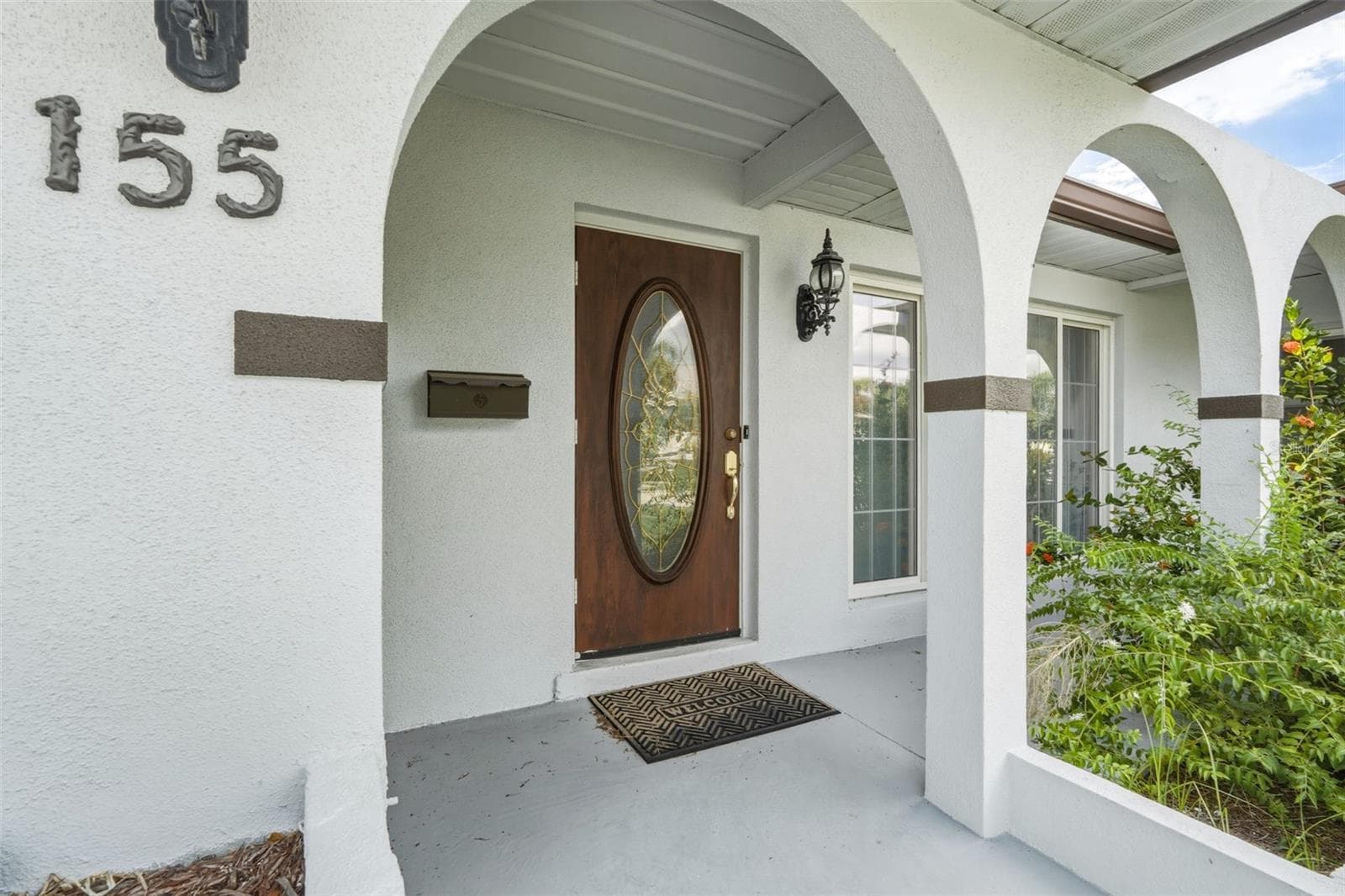 Inviting Exterior Showcasing the Homes Covered Entry - 155 MORGAN LN SE, PORT CHARLOTTE