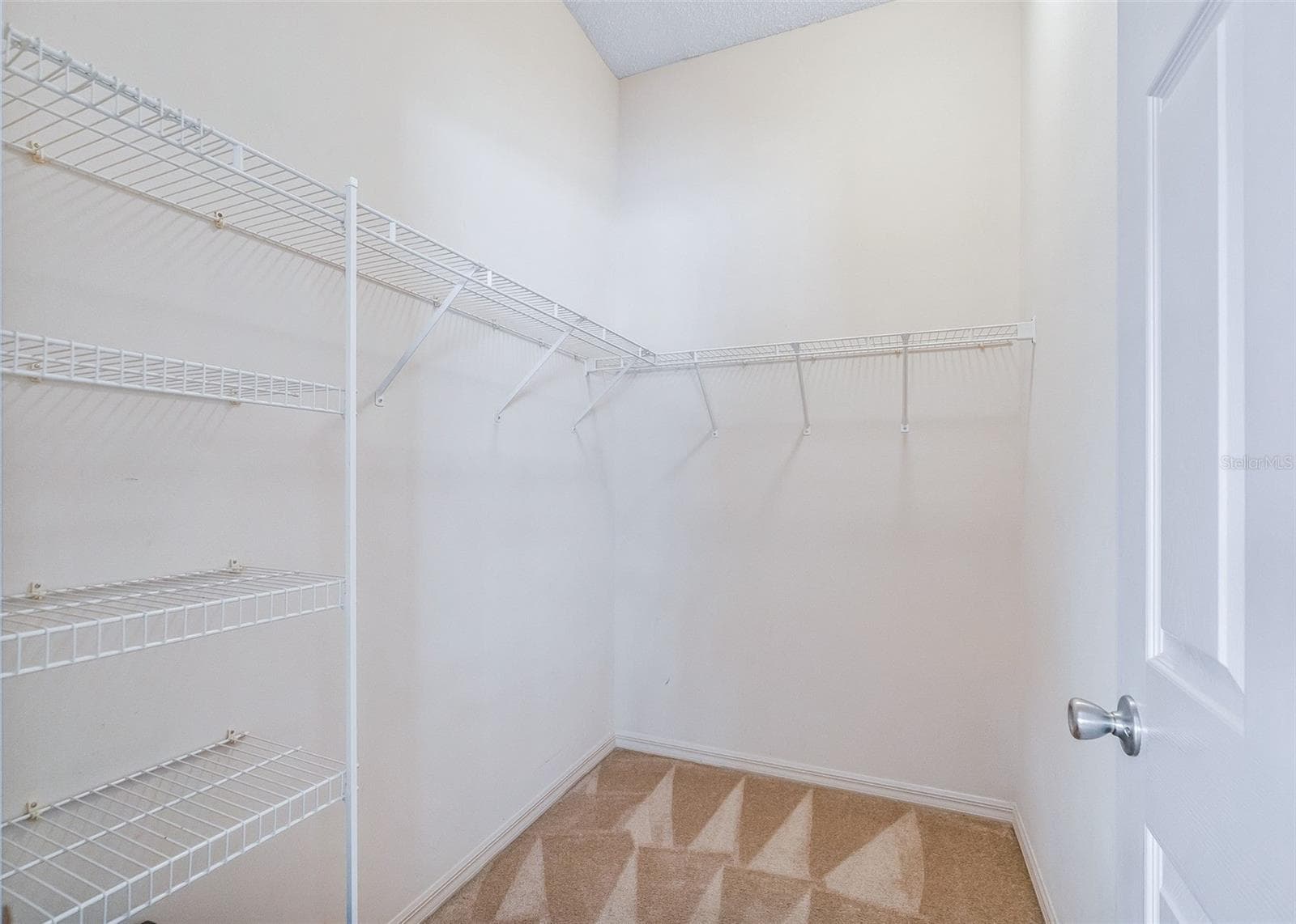 Spacious walk-in closet in the primary bedroom - 17535 SE 84TH FOXGROVE AVE, THE VILLAGES