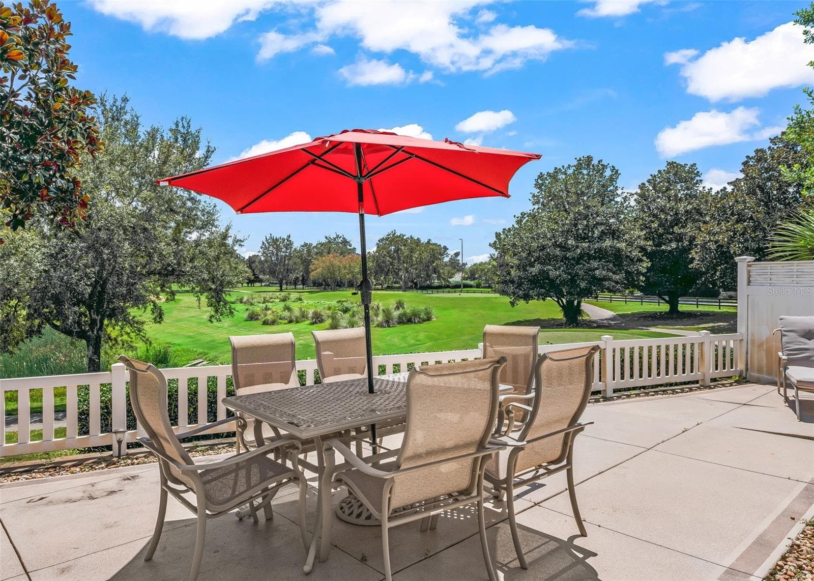 Spacious private courtyard with plenty of room to relax, entertain, and soak up the Florida sunshine. Enjoy beautiful golf course views from this inviting outdoor retreat, offering the perfect setting to unwind and enjoy the Florida lifestyle. - 17535 SE 84TH FOXGROVE AVE, THE VILLAGES
