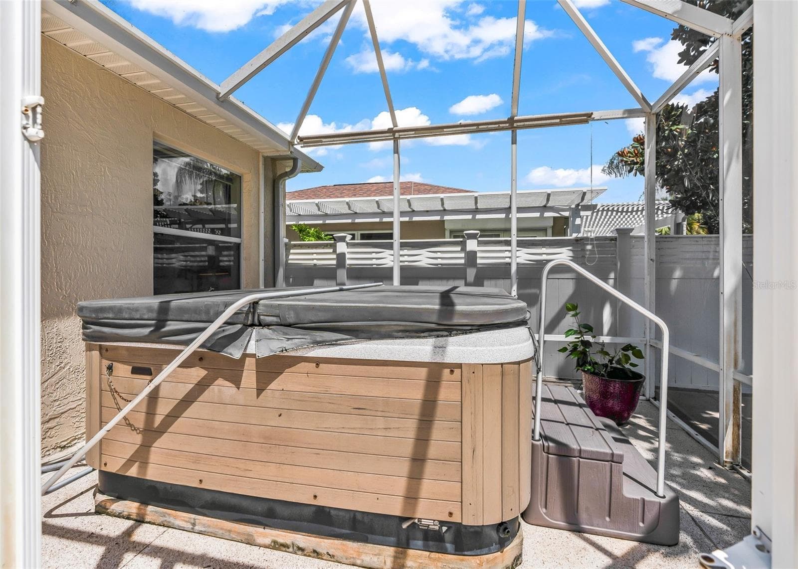 Screened-in enclosure offering a comfortable space with plenty of room for a hot tub, creating the perfect spot to relax and unwind while enjoying the Florida lifestyle. - 17535 SE 84TH FOXGROVE AVE, THE VILLAGES