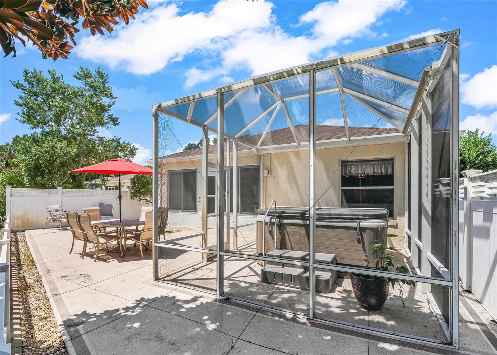 Private courtyard featuring a screened-in enclosure with flexible space for a hot tub, outdoor seating, or your own personalized outdoor retreat. This versatile area offers additional outdoor living space, perfect for relaxing and enjoying the Florida lifestyle. - 17535 SE 84TH FOXGROVE AVE, THE VILLAGES