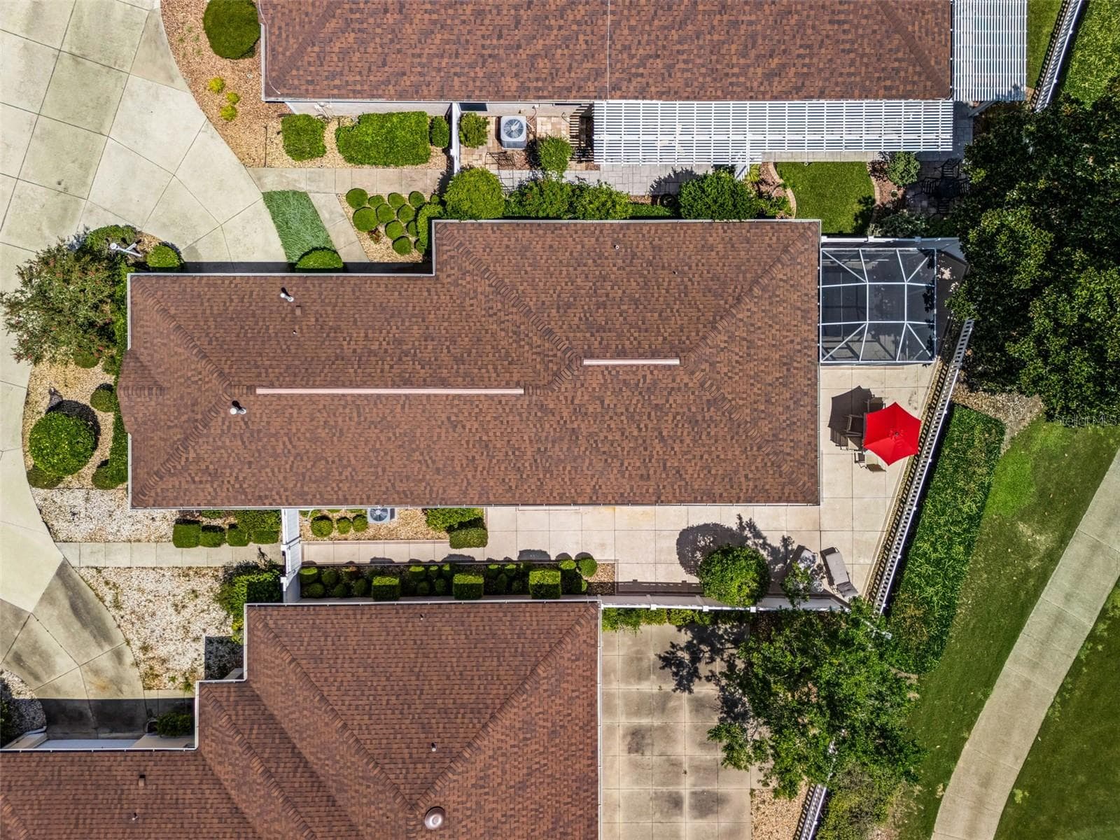 Aerial view showcasing the home, private courtyard, golf course frontage, and surrounding mature landscaping. A beautiful perspective of the property and its desirable setting. - 17535 SE 84TH FOXGROVE AVE, THE VILLAGES