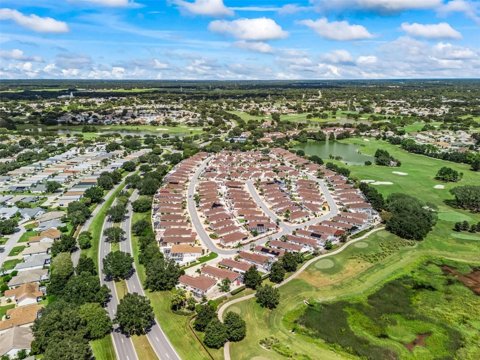 Aerial view highlighting the home’s attractive setting within the surrounding neighborhood. - 17535 SE 84TH FOXGROVE AVE, THE VILLAGES