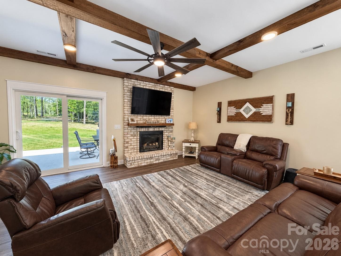 Living room with new wood beams, lighting, and stone fireplace - 9201 Providence Road S, Waxhaw